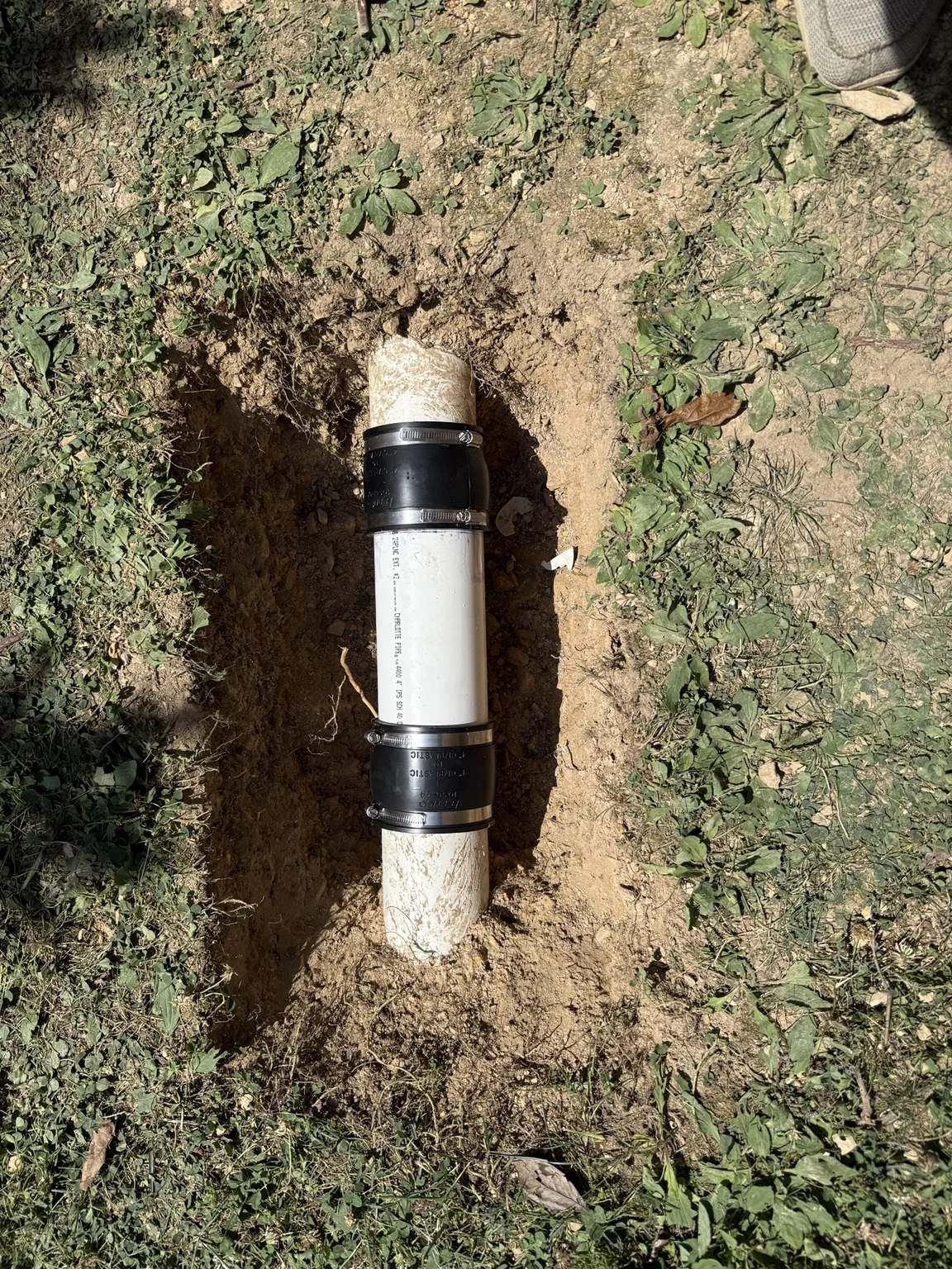 Drain and pipe repair with new PVC section and shielded couplings