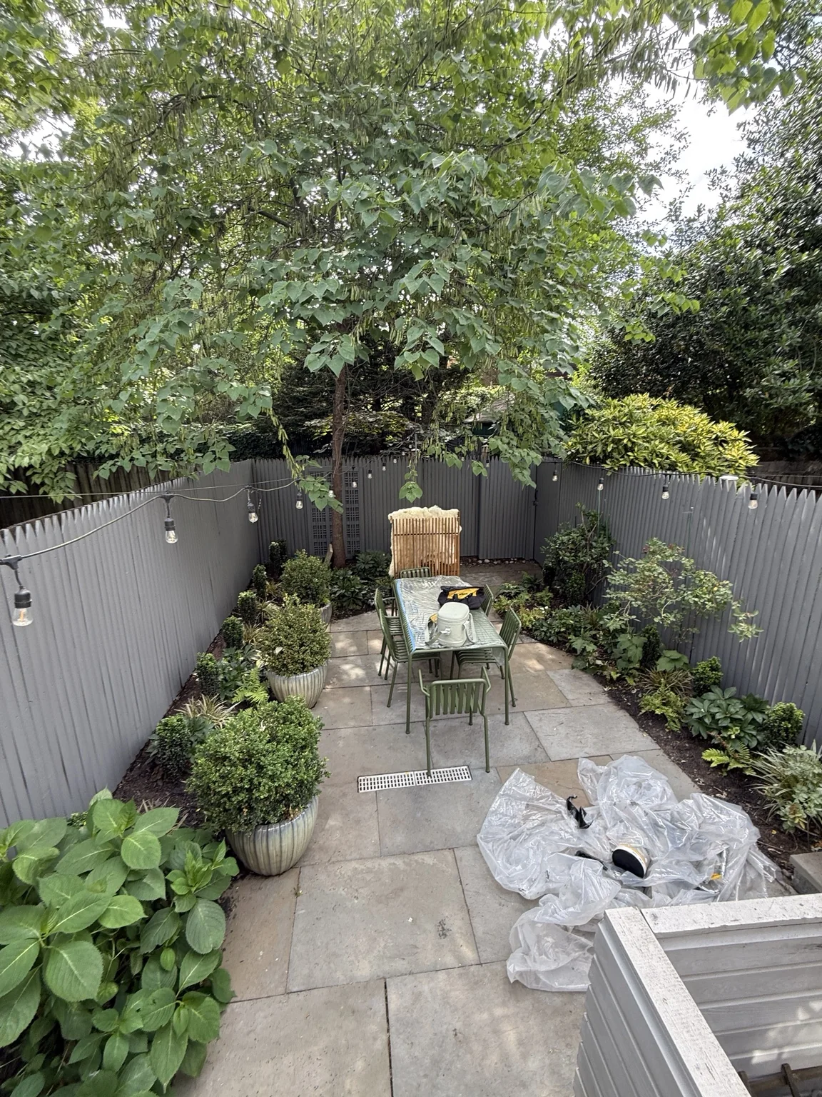 Gray fence restored with matching paint