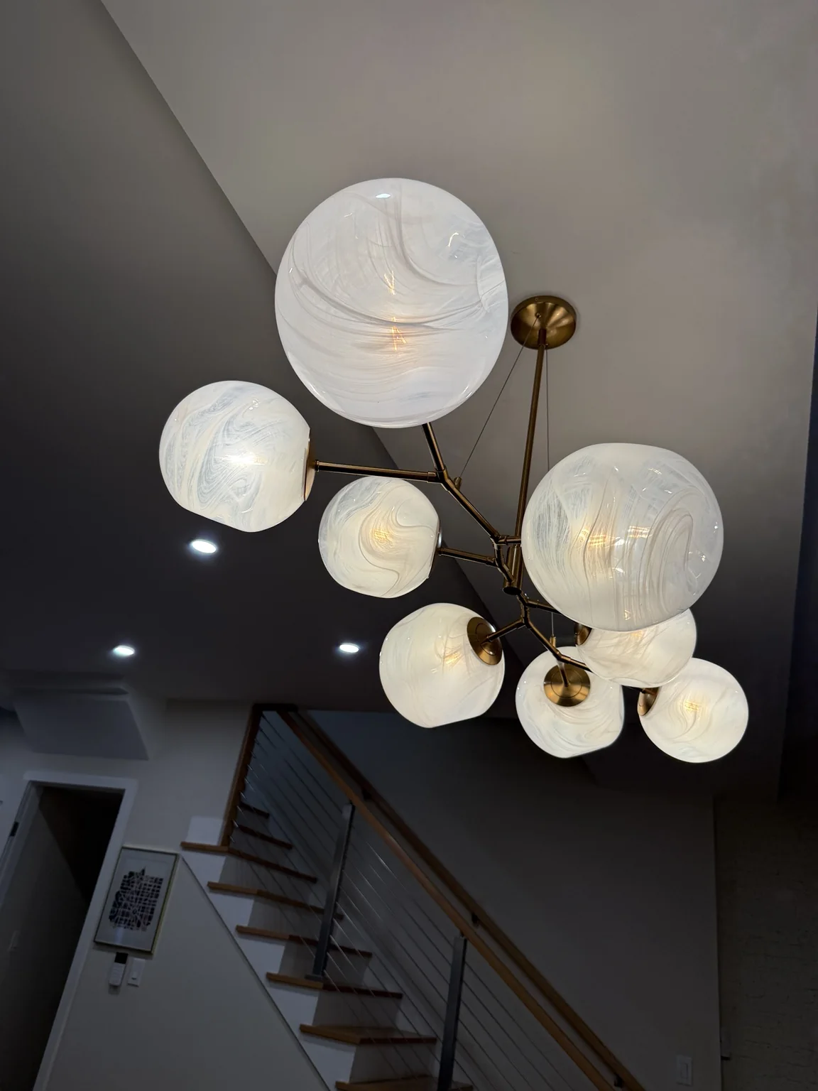 Statement chandelier and recessed lighting installation