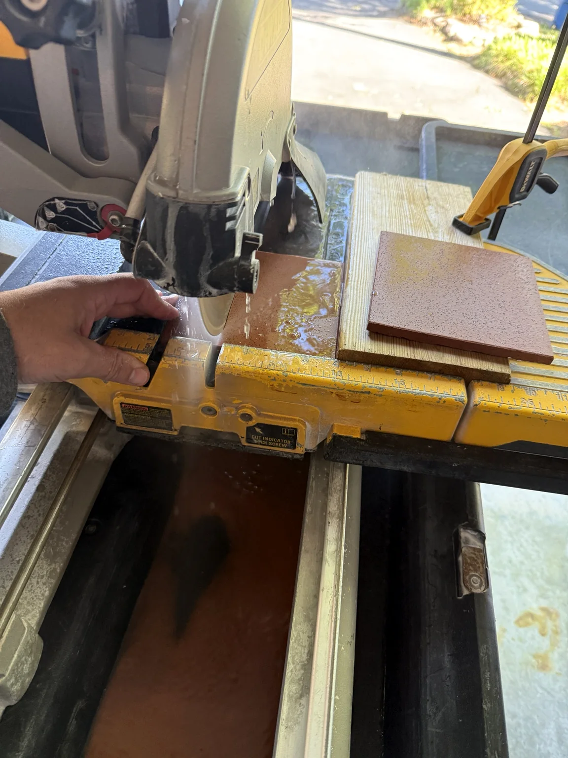 Italian tile being wet-cut for the fireplace repair