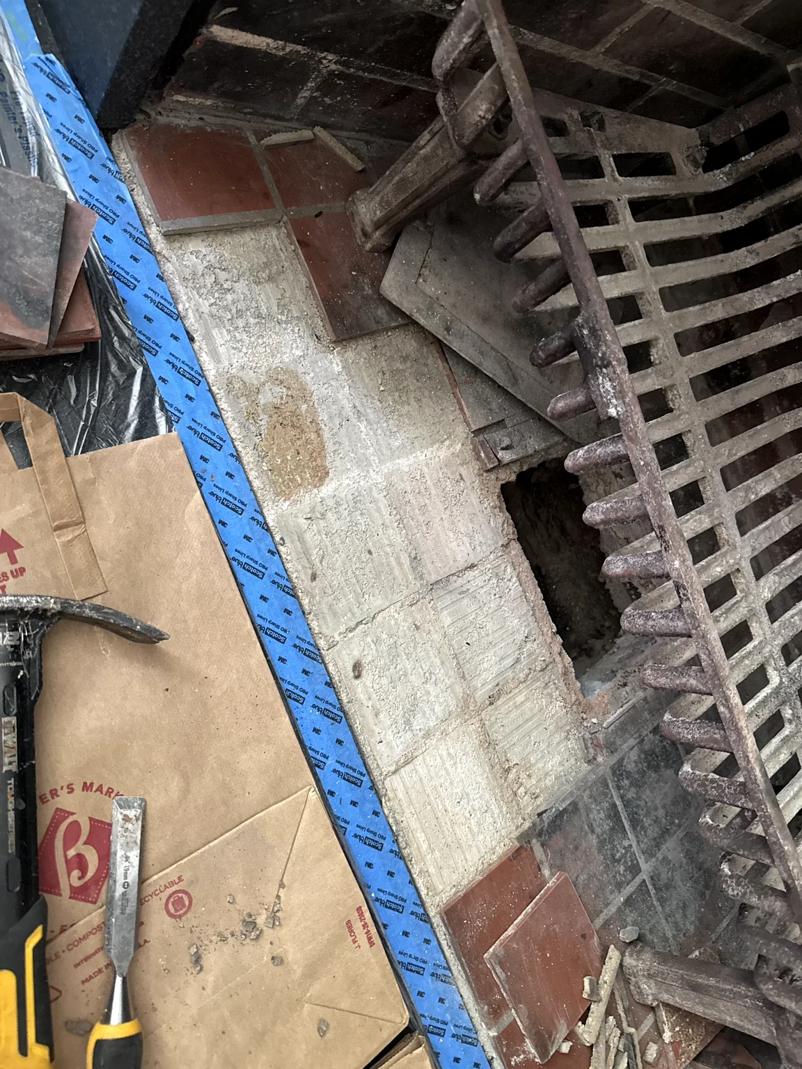 Fireplace tile removed to expose the repair area