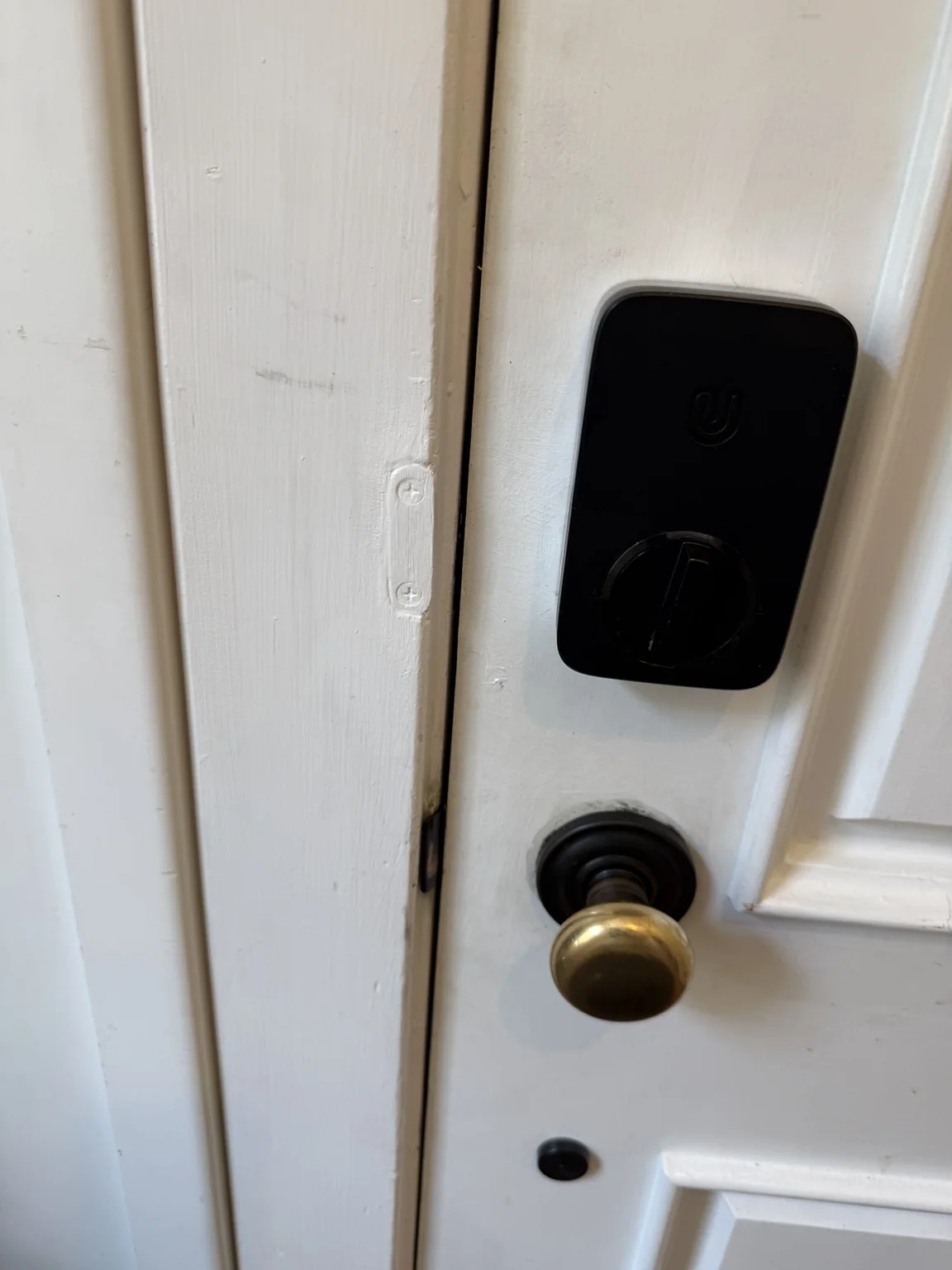 Black smart lock with custom white metal spacer